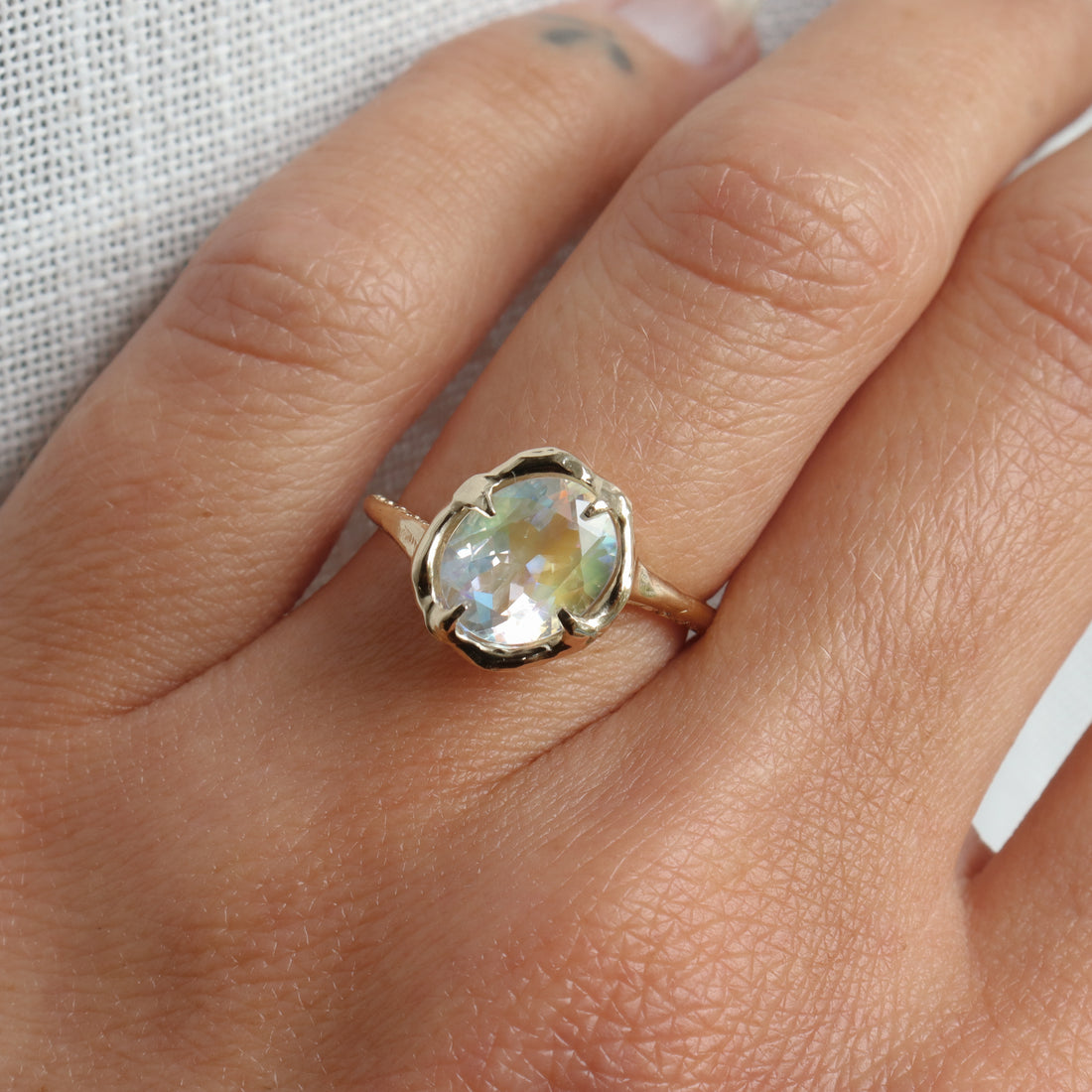Gold ring with a gemstone on a person&