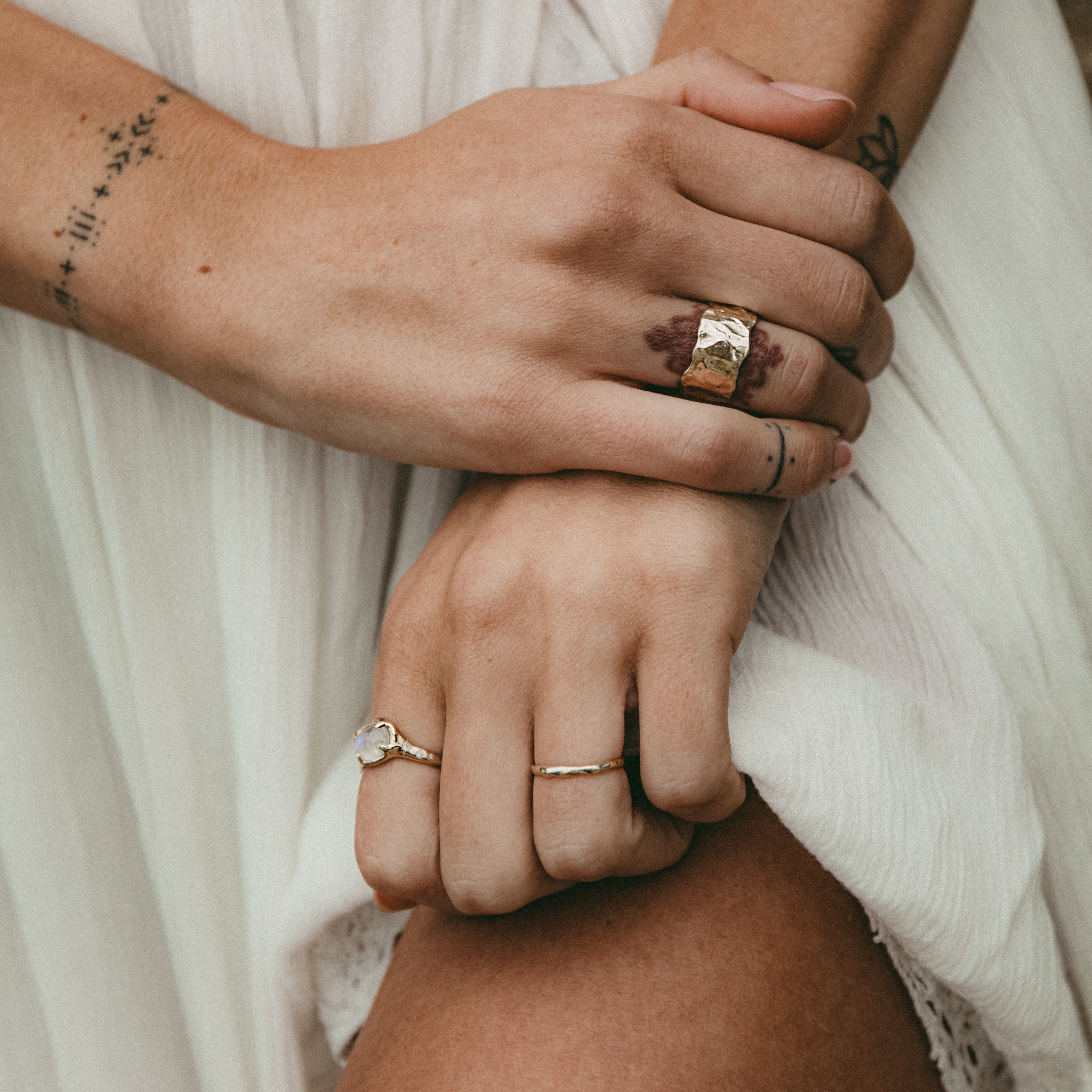 gold stacking rings with moonstones, opals, and diamonds
