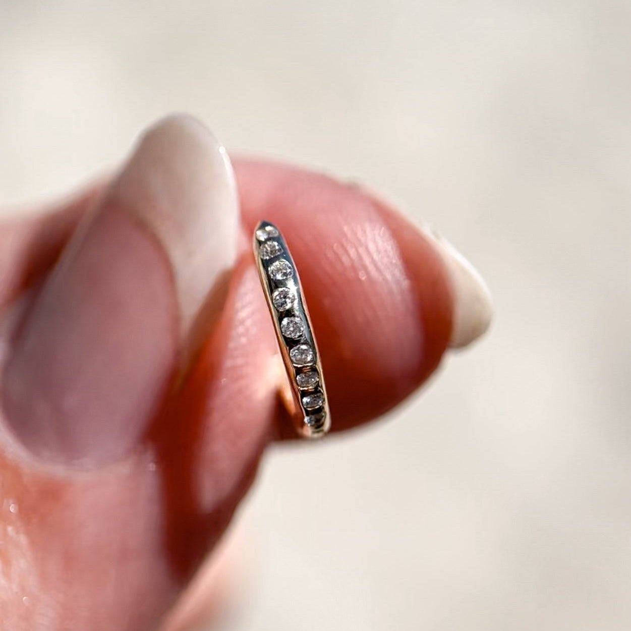 flush set diamond hoops held in hand