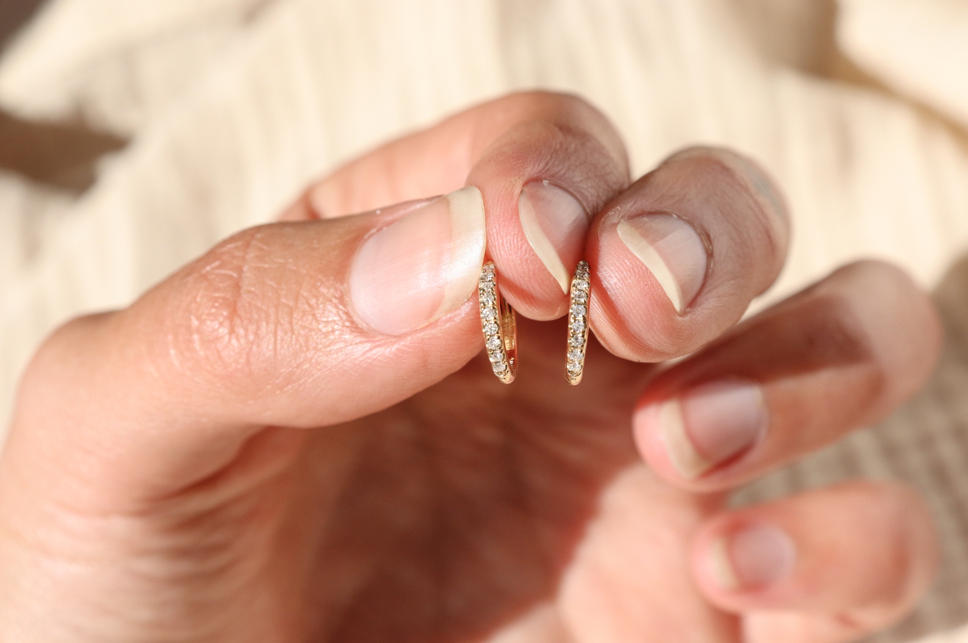 front view close up of a pair of pave diamond gold hoops