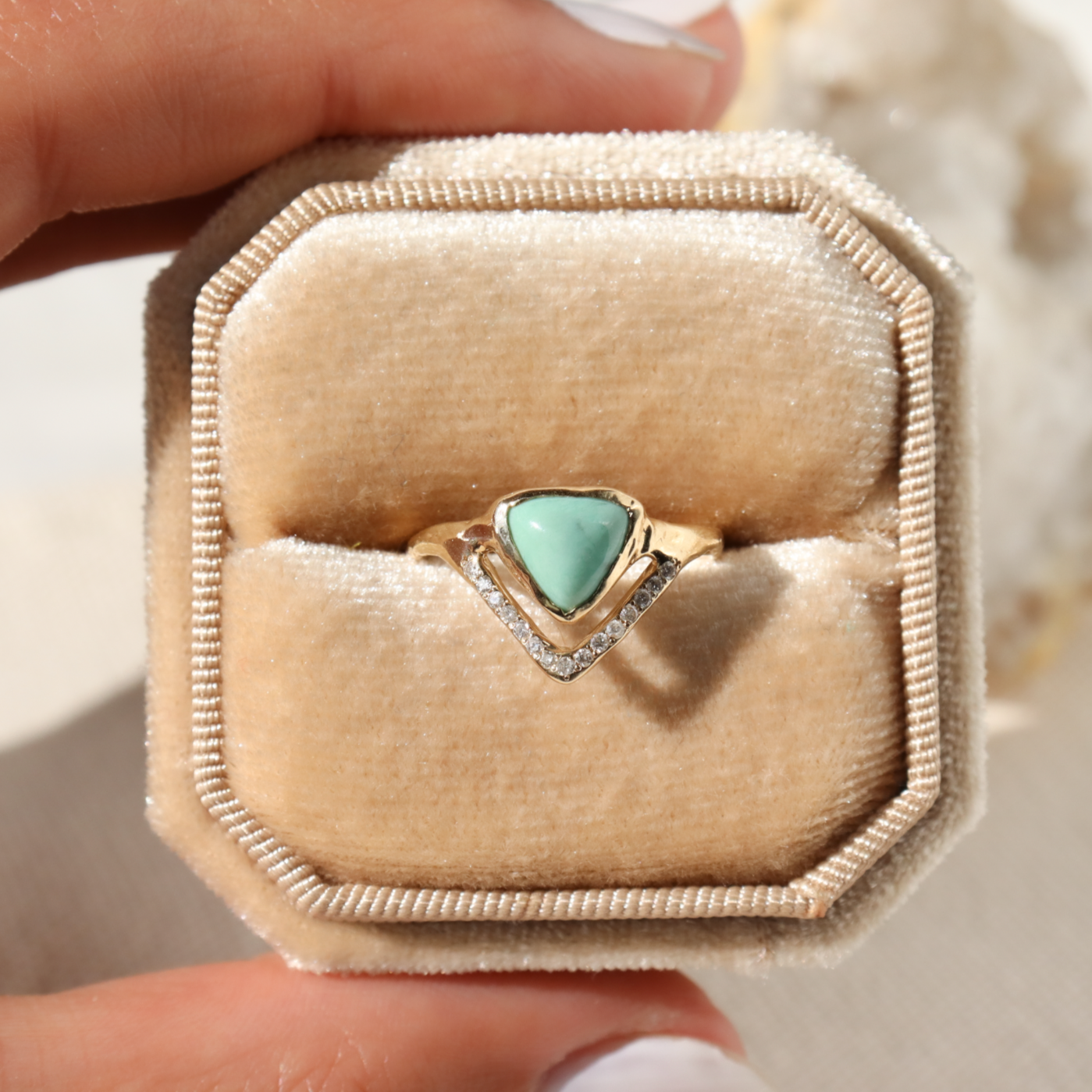 a trillion variscite ring sits inside a velvet ring box