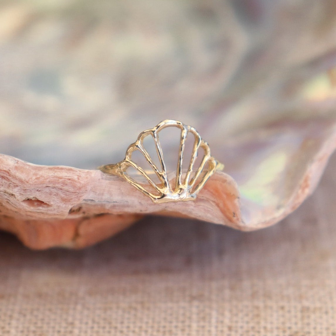 Close-up of an exquisite seashell ring, showcasing intricate details and a natural, shell centerpiece, capturing the essence of coastal beauty and ocean-inspired jewelry design.