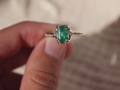 up close detail video of a 14k gold emerald ring with diamond details