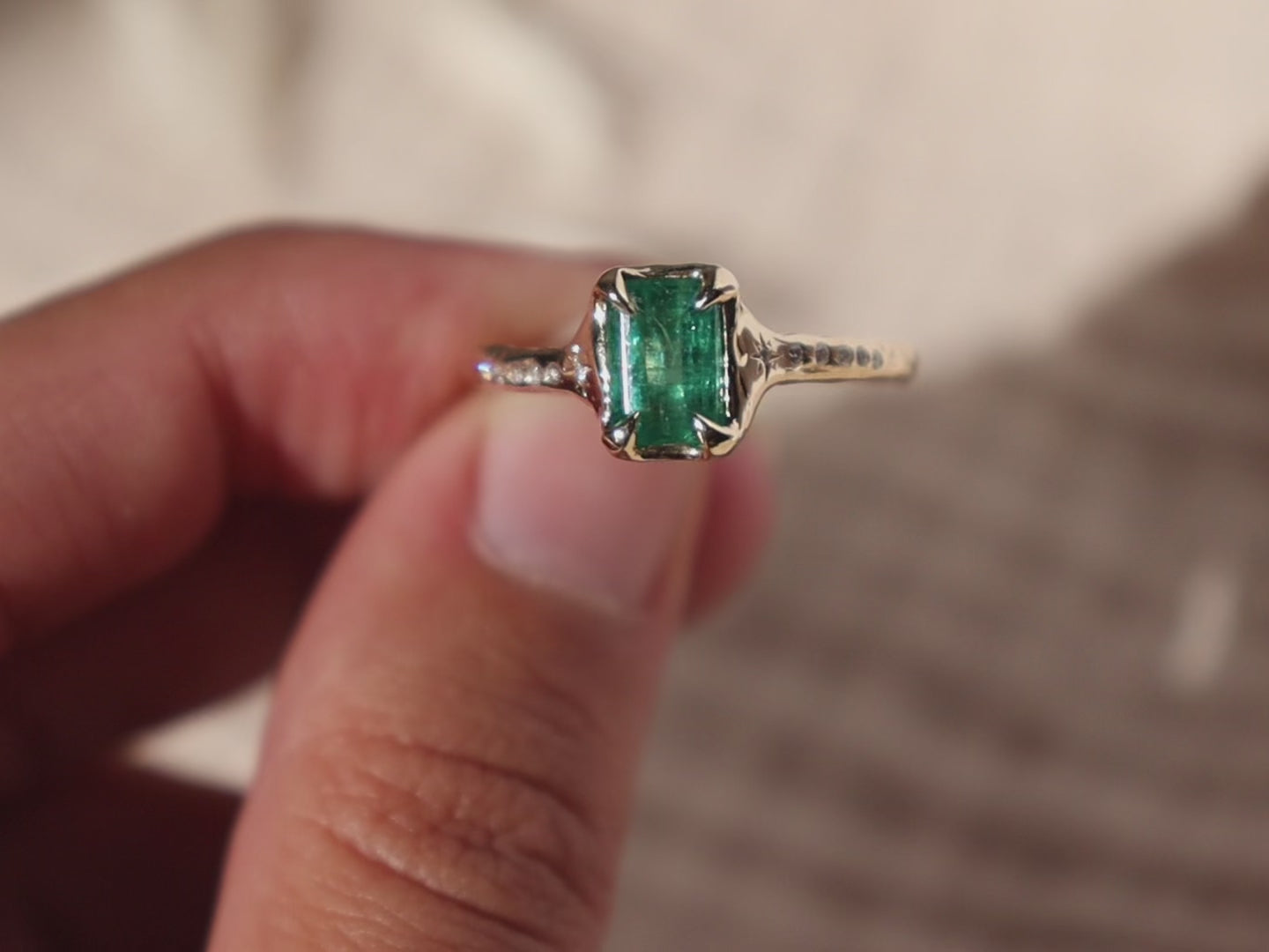up close detail video of a 14k gold emerald ring with diamond details