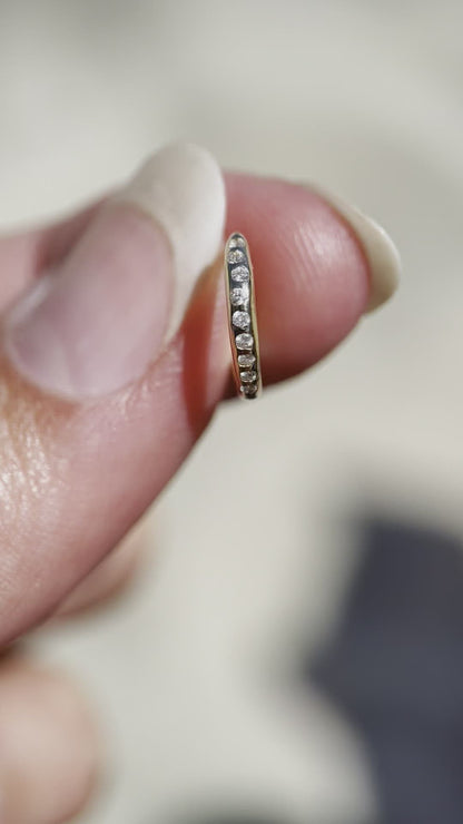 a video of a close up of a flush set diamond gold hoop