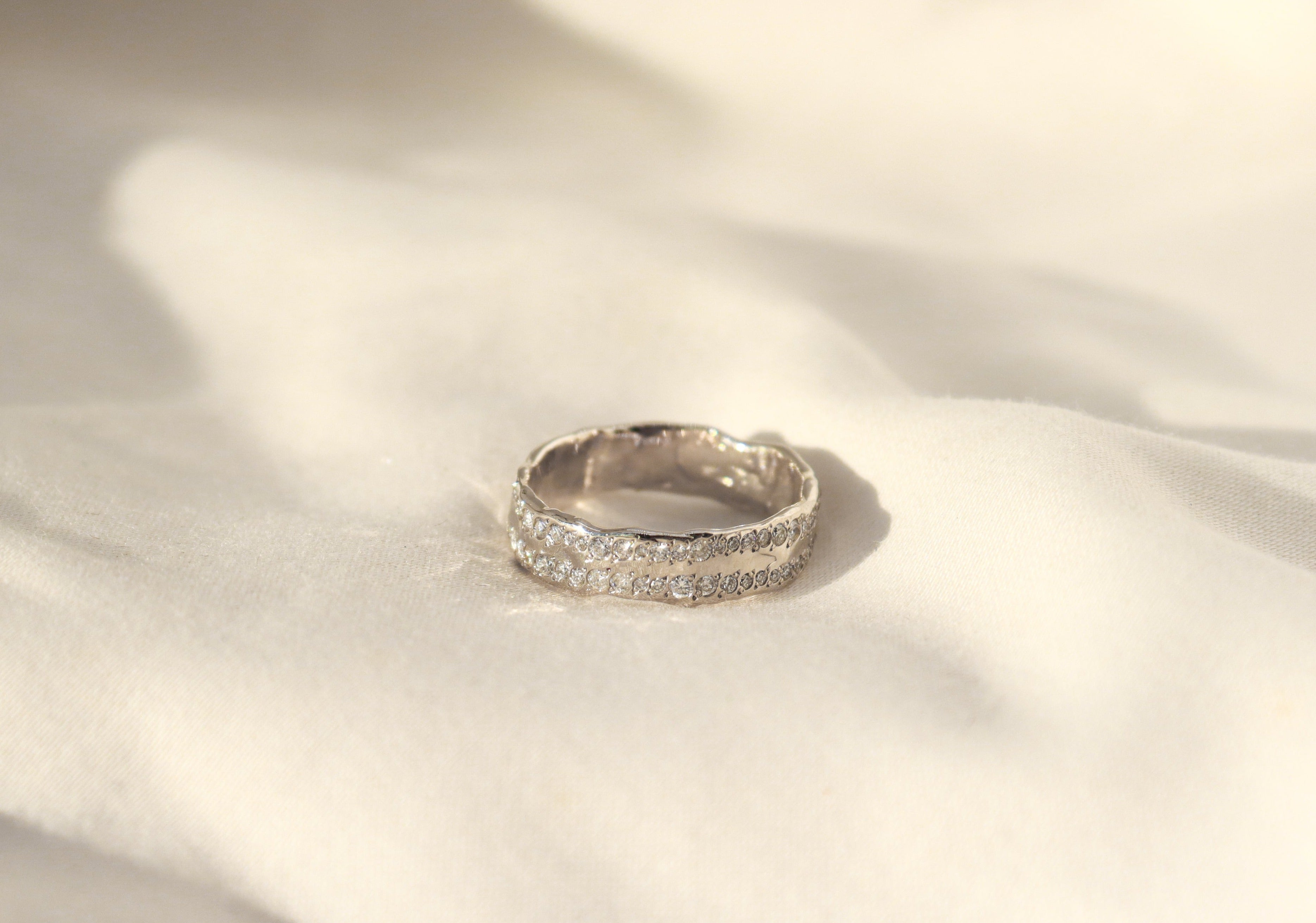 womens 14k white gold wedding band with two rows of pave diamonds and an organic texture