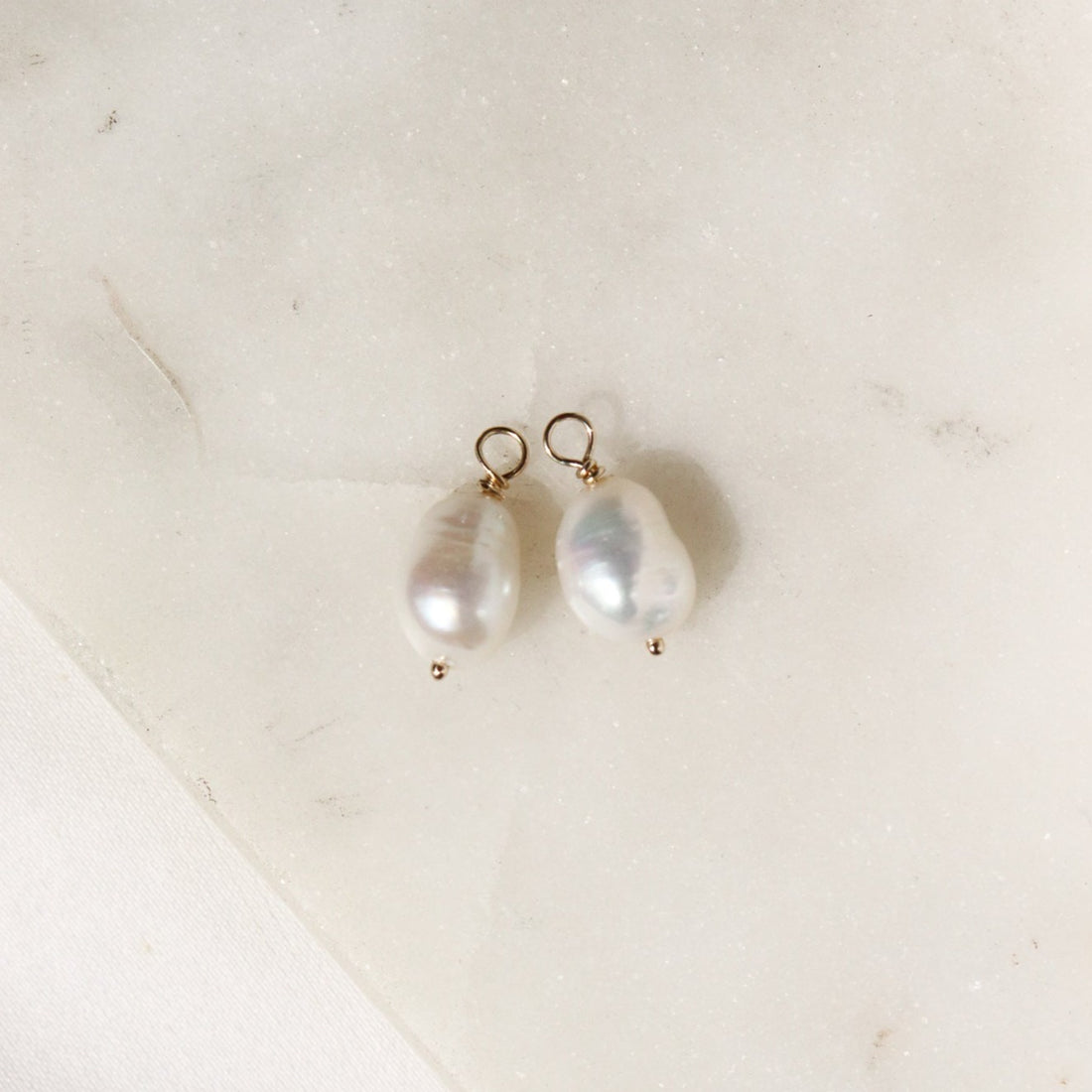 Baroque pebble pearl hoop charm on white background
