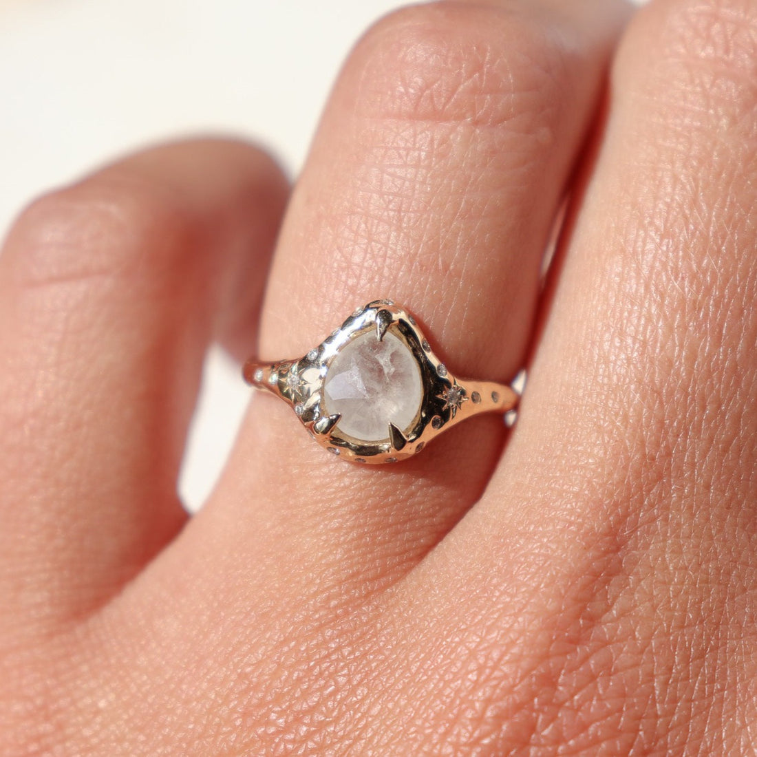 Close up of an icy diamond ring being worn on the ring finger