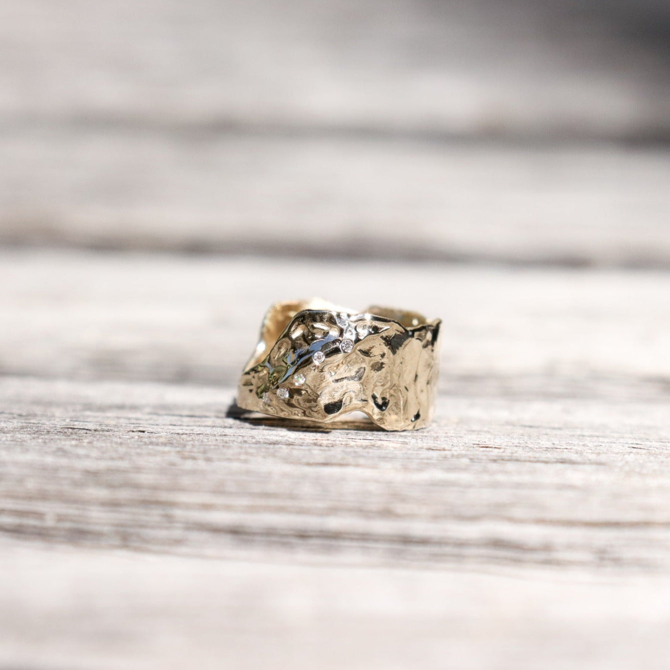 Wide gold band with diamonds