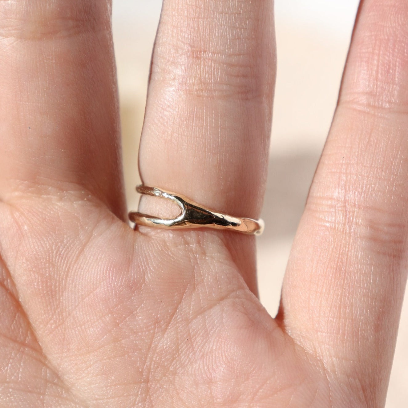 back view of a small pear shaped opal set in 14k gold with an asymmetric band design