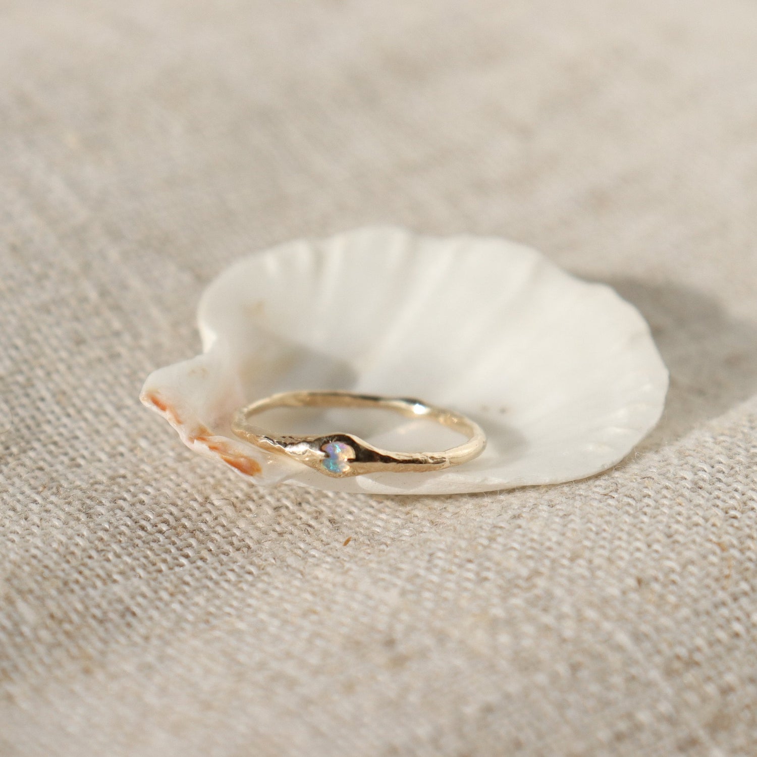 tiny opal stacking band set in a seashell