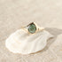 A rose cut blue green tourmaline is set in 14k  gold  into a signet style ring.