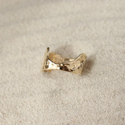 Front view of a wide textured band with a dip in the front to allow for stacking with a larger gemstone ring.