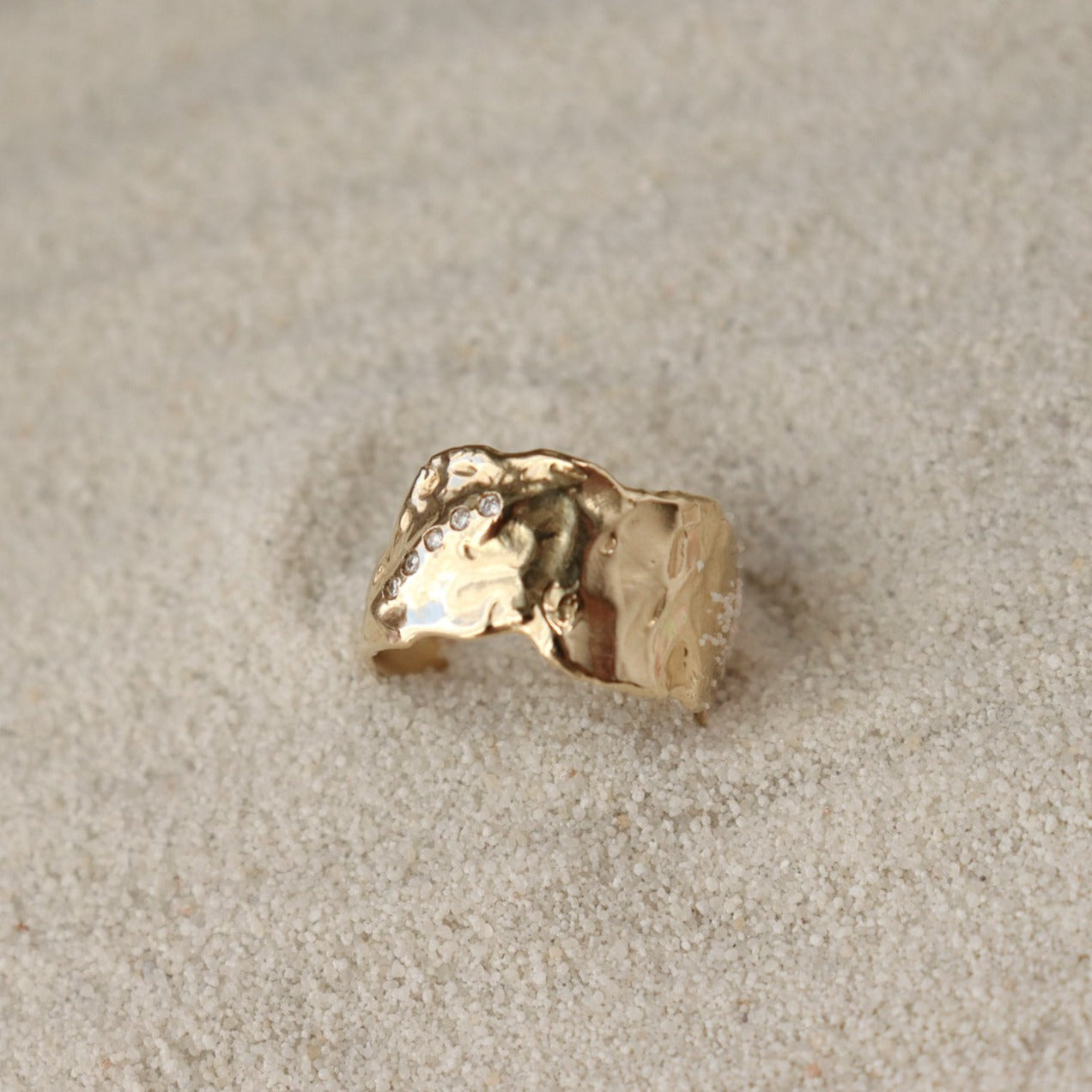 Side view of a wide textured band with diamonds along the side.