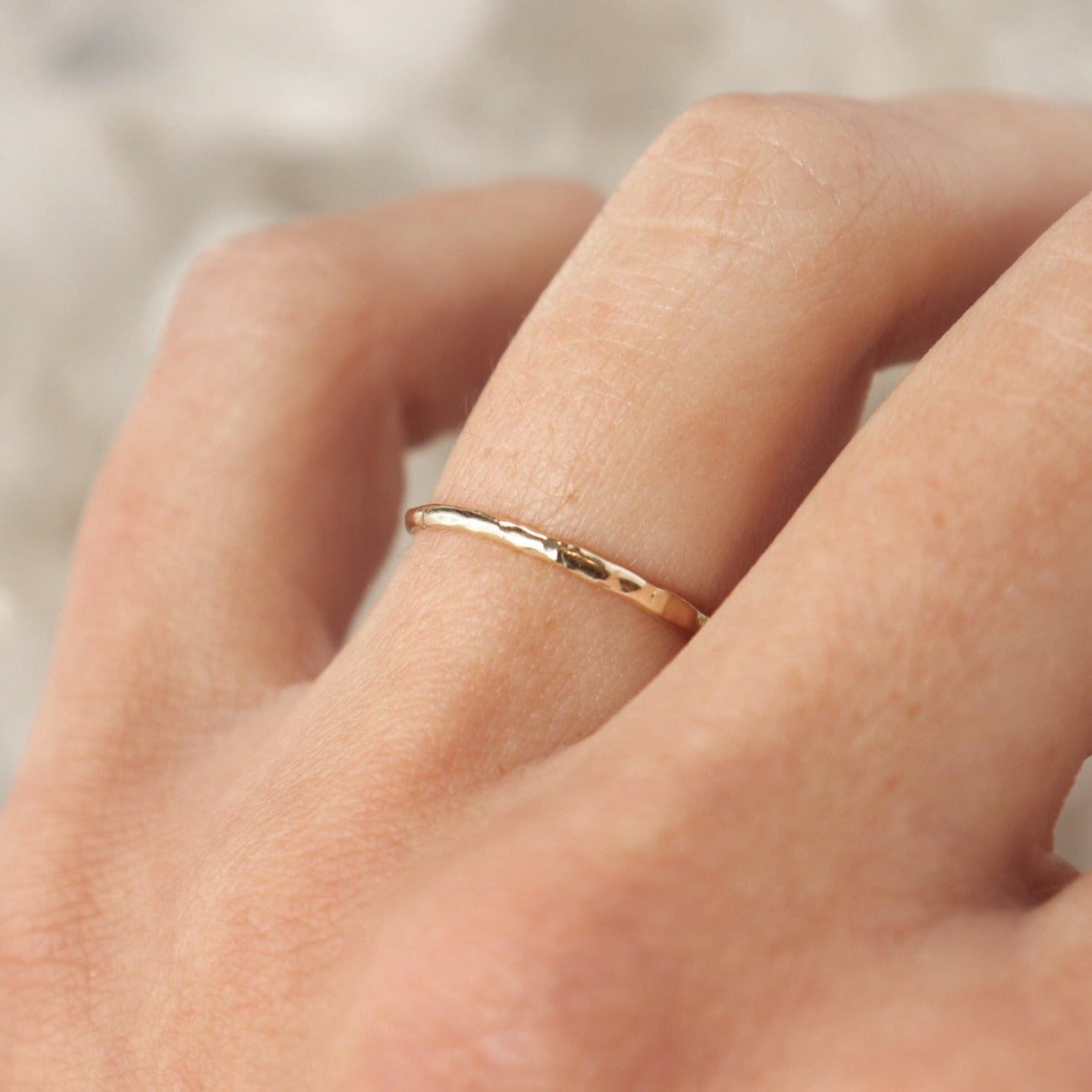 An ultra narrow 14k gold organic stacking band.