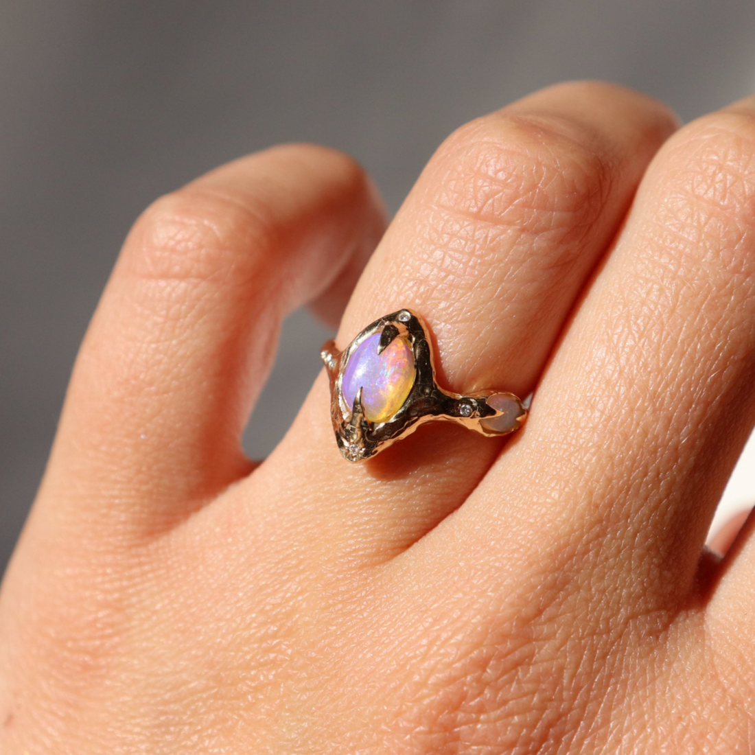 gold pipe opal ring is worn on a ring finger