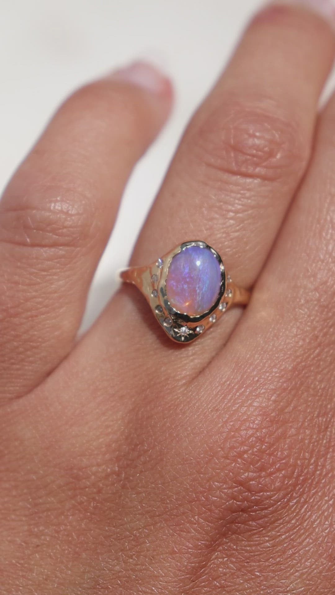 video of a gold pipe opal ring with flush set diamonds