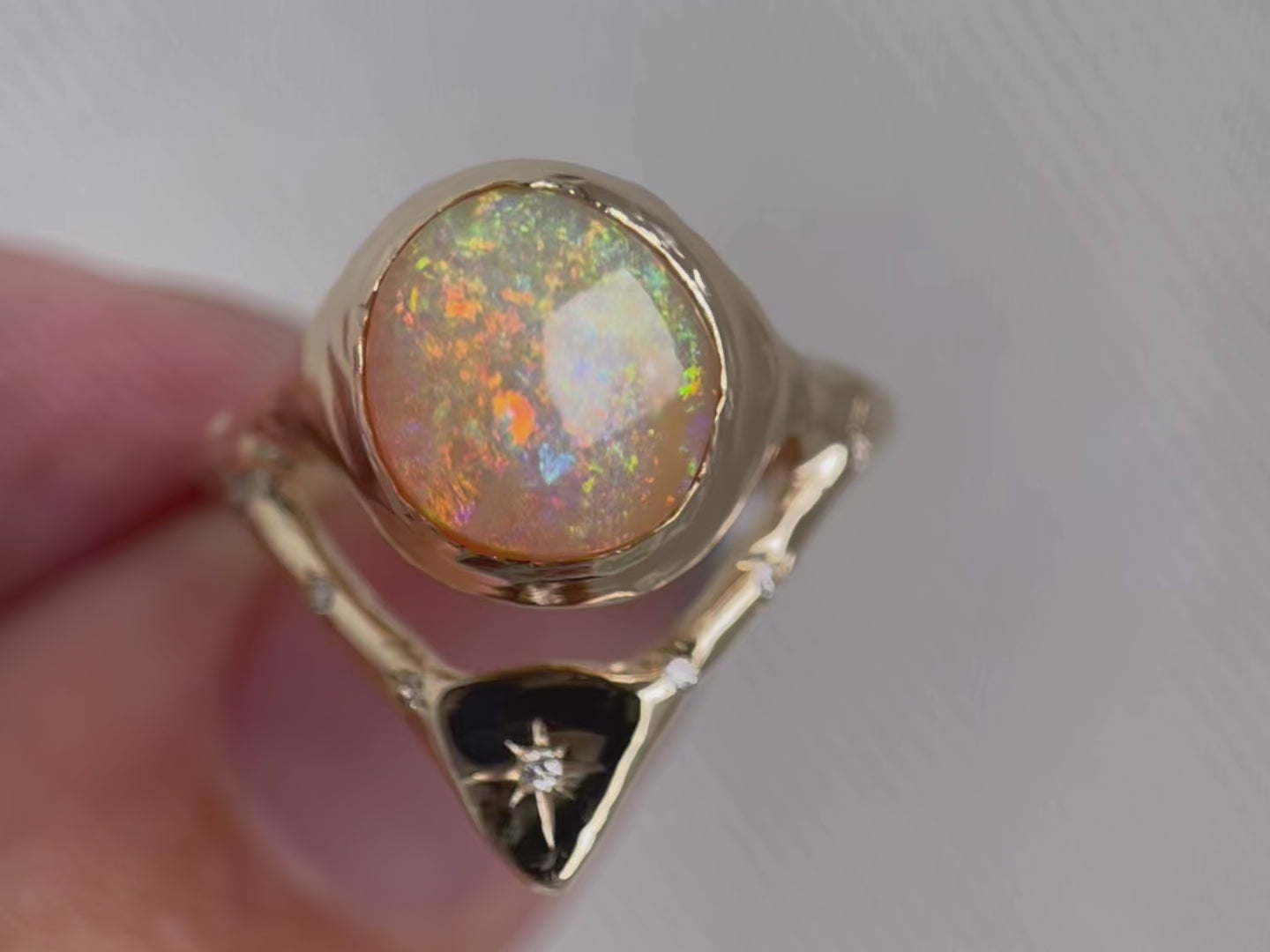 a video highlighting the colors in the opal and the diamond details