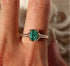 emerald cut emerald ring set in 14k gold with diamond accents