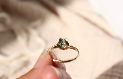 back detail view showing a moon cut out on the bottom of the gold emerald ring